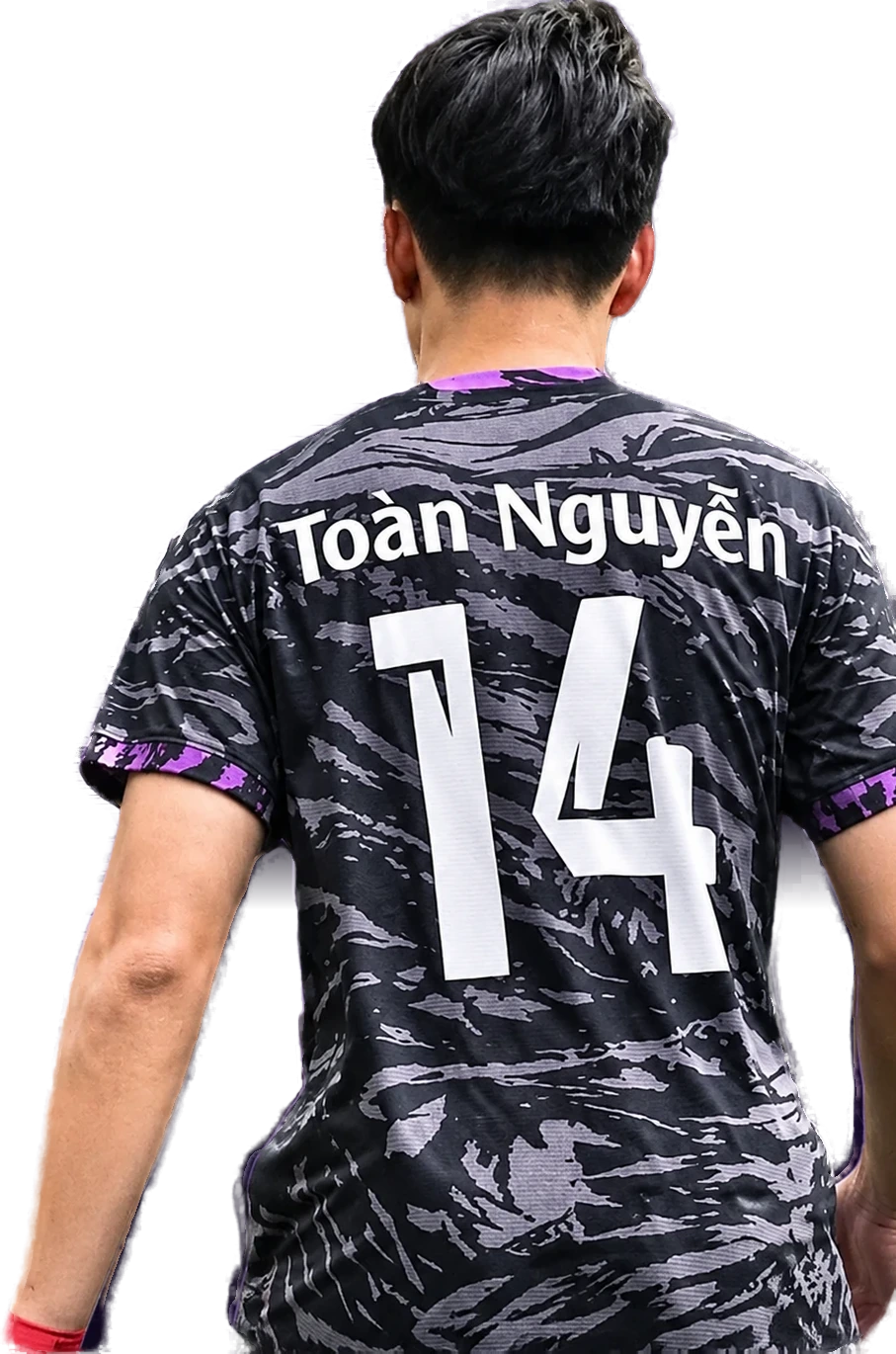 Nguyen Duc Toan seen from behind in his school-team shirt, No. 14